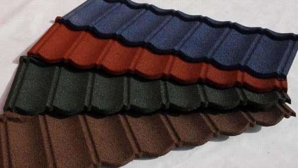 Stone-coated roofing tiles installed on a building roof