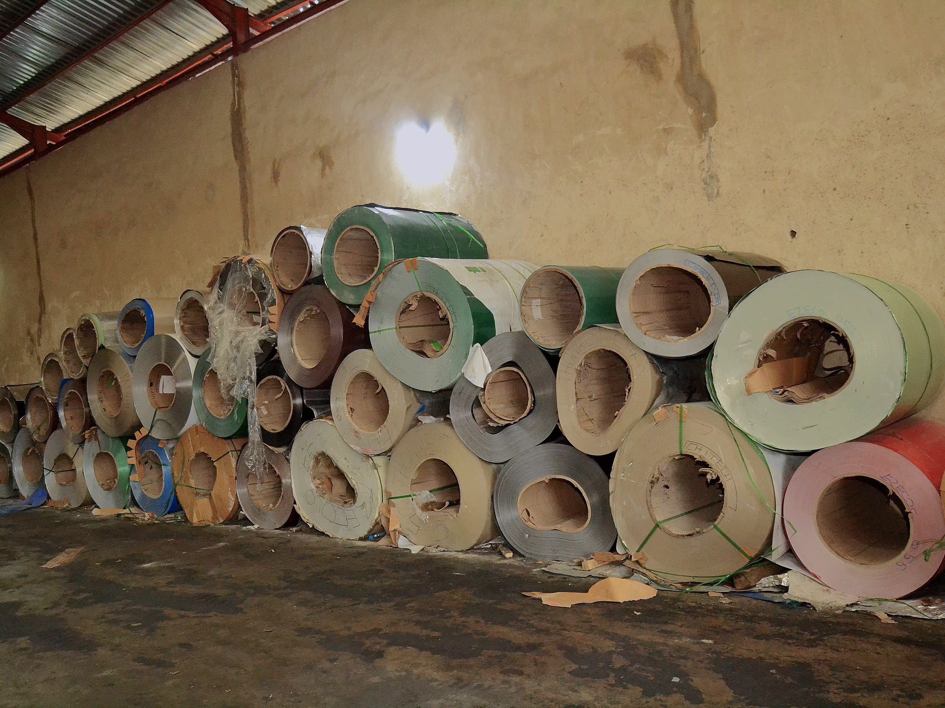 Inside the Gods Promise Aluminium factory showing a bright, organised workshop and finished roofing sheets.