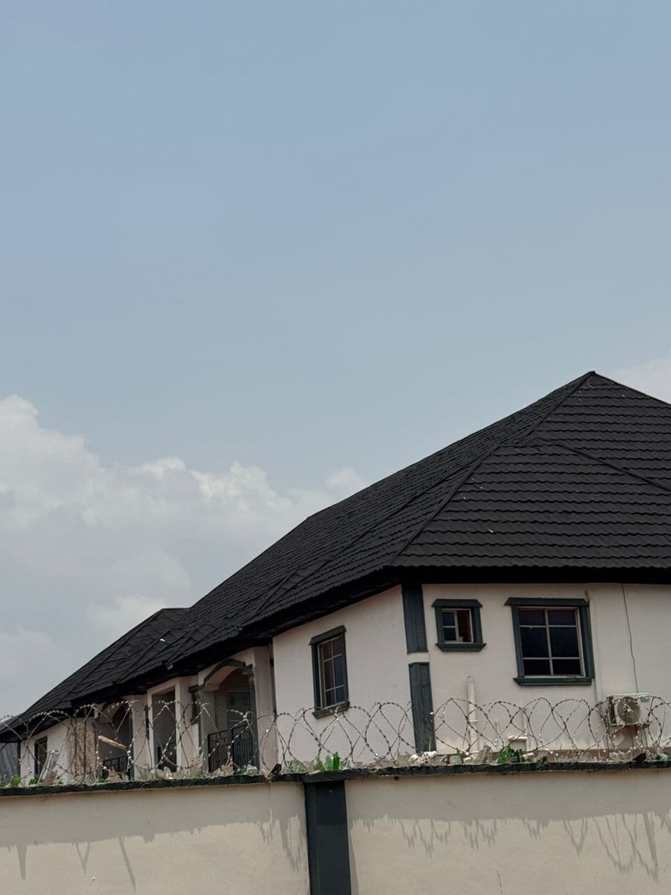 Stone-coated roofing tiles installed on a building in Lagos Nigeria — 2026 authorized dealer price guide