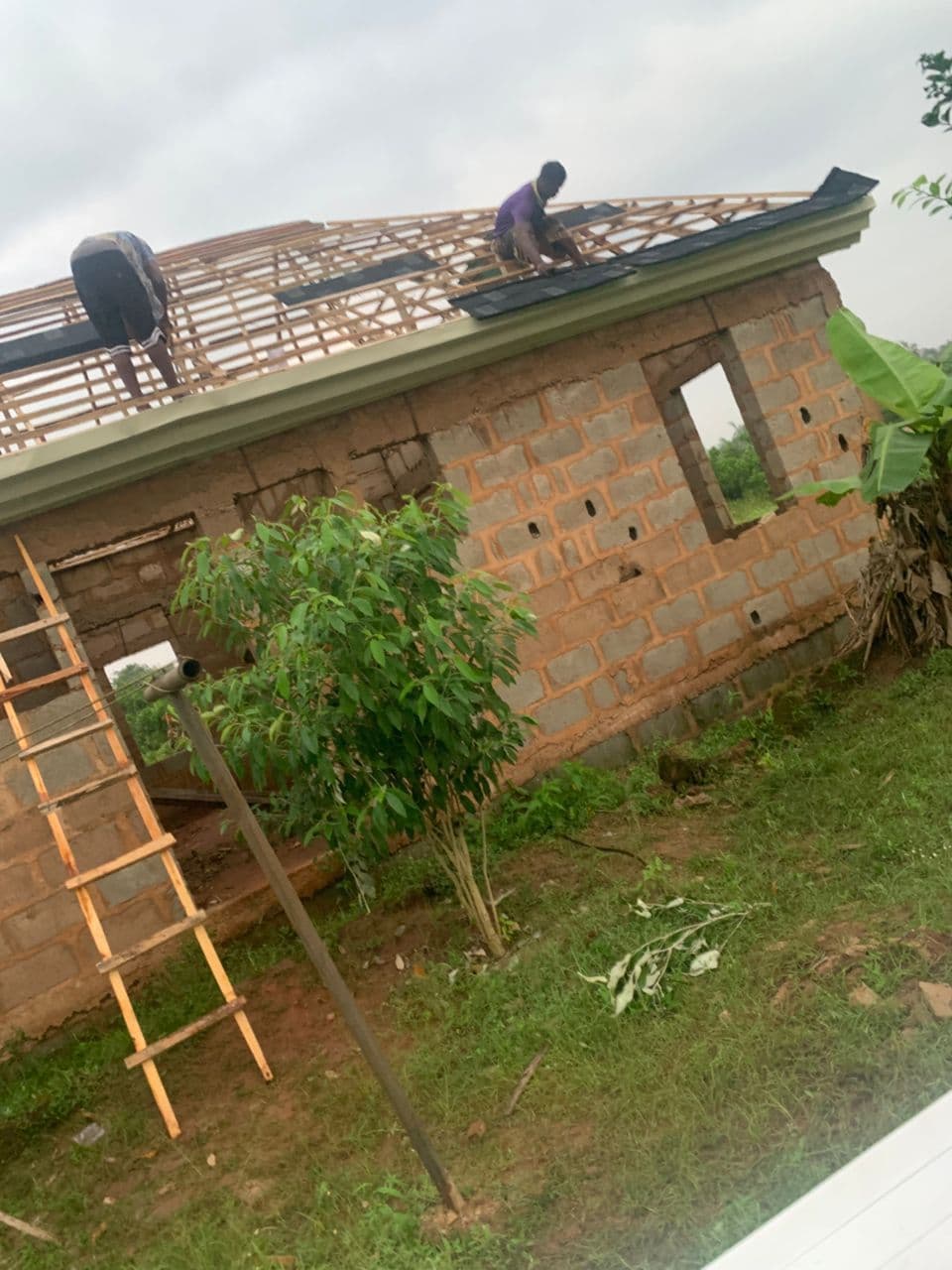 Stone coated roof tiles being installed on a residential building in Lagos — installation cost guide 2026